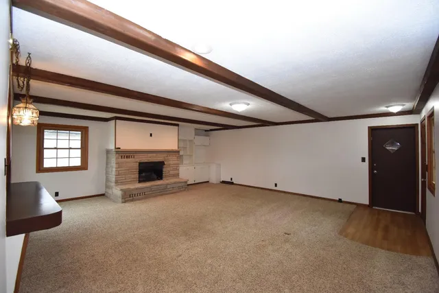 wooden floor in an empty room with a fireplace