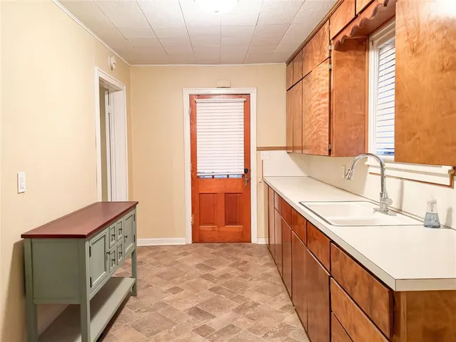 a spacious bathroom with a granite countertop sink and a bathtub