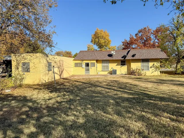 a front view of a house with a big yard