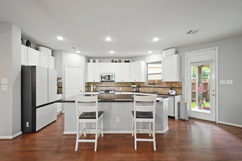 a kitchen with a table and chairs
