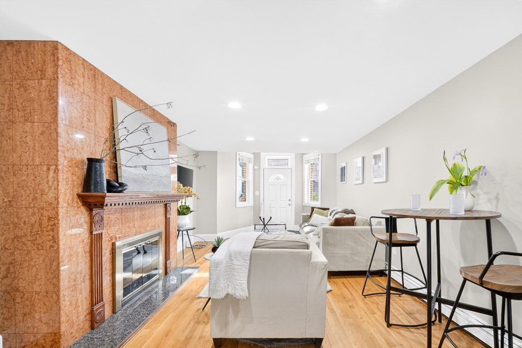 352 Tappan Street, Unit 1 Brookline, MA 02445 - Photo 39 of 42 a living room with furniture a fireplace and a table