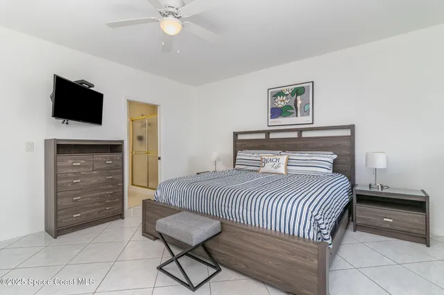 a bedroom with a bed and a television