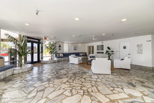 a living room with furniture and kitchen view