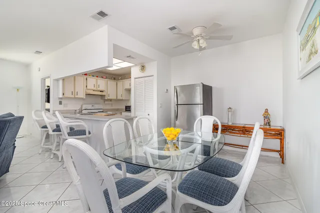 a dining room with furniture and a view of kitchen