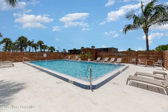a view of a tennis ground with large trees