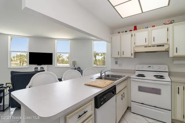 a kitchen with cabinets appliances a sink and a stove