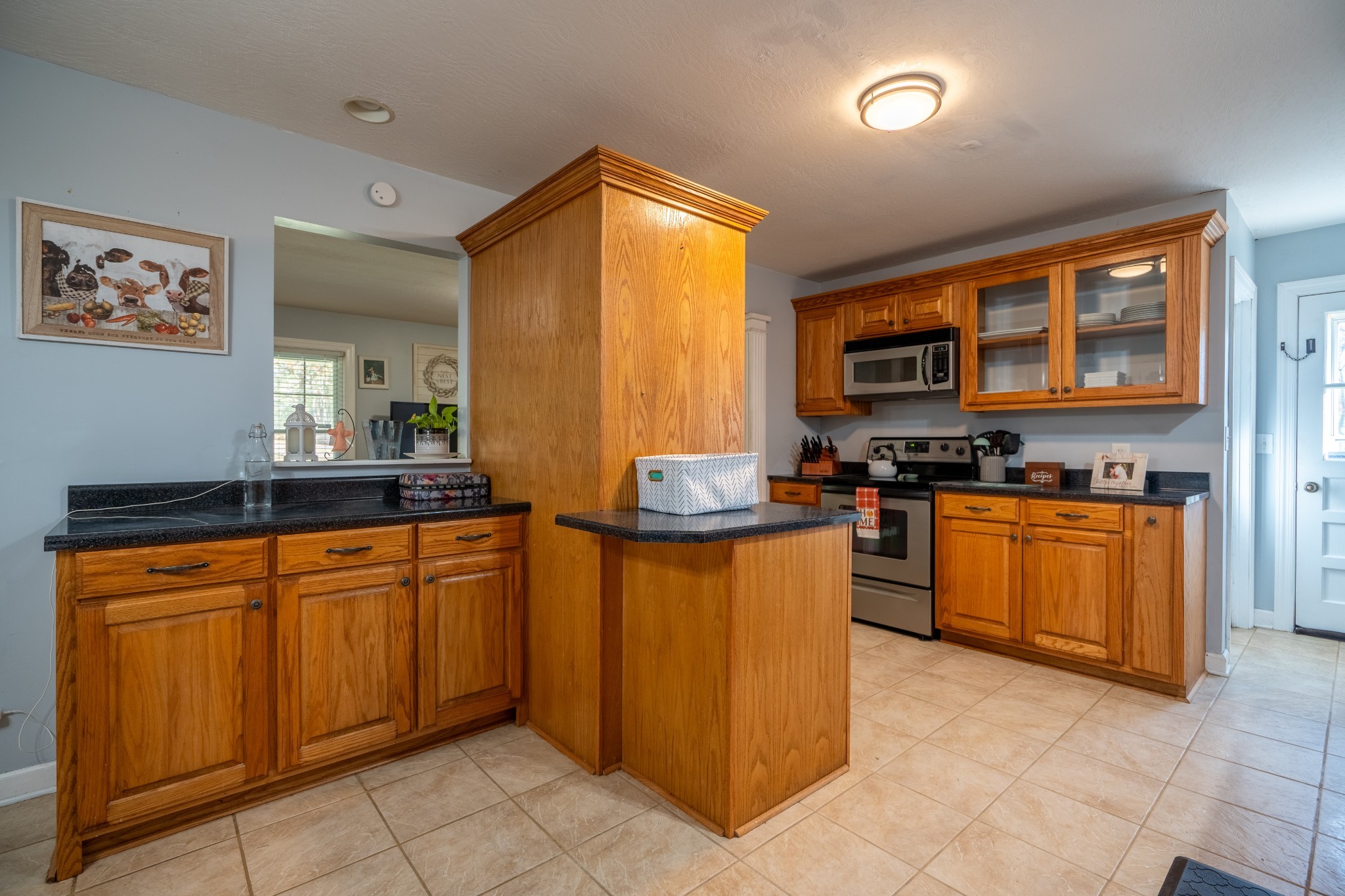 27 Tandy Road Leoma, TN 38468 - Photo 17 of 27 a kitchen with stainless steel appliances granite countertop a stove a sink and a microwave