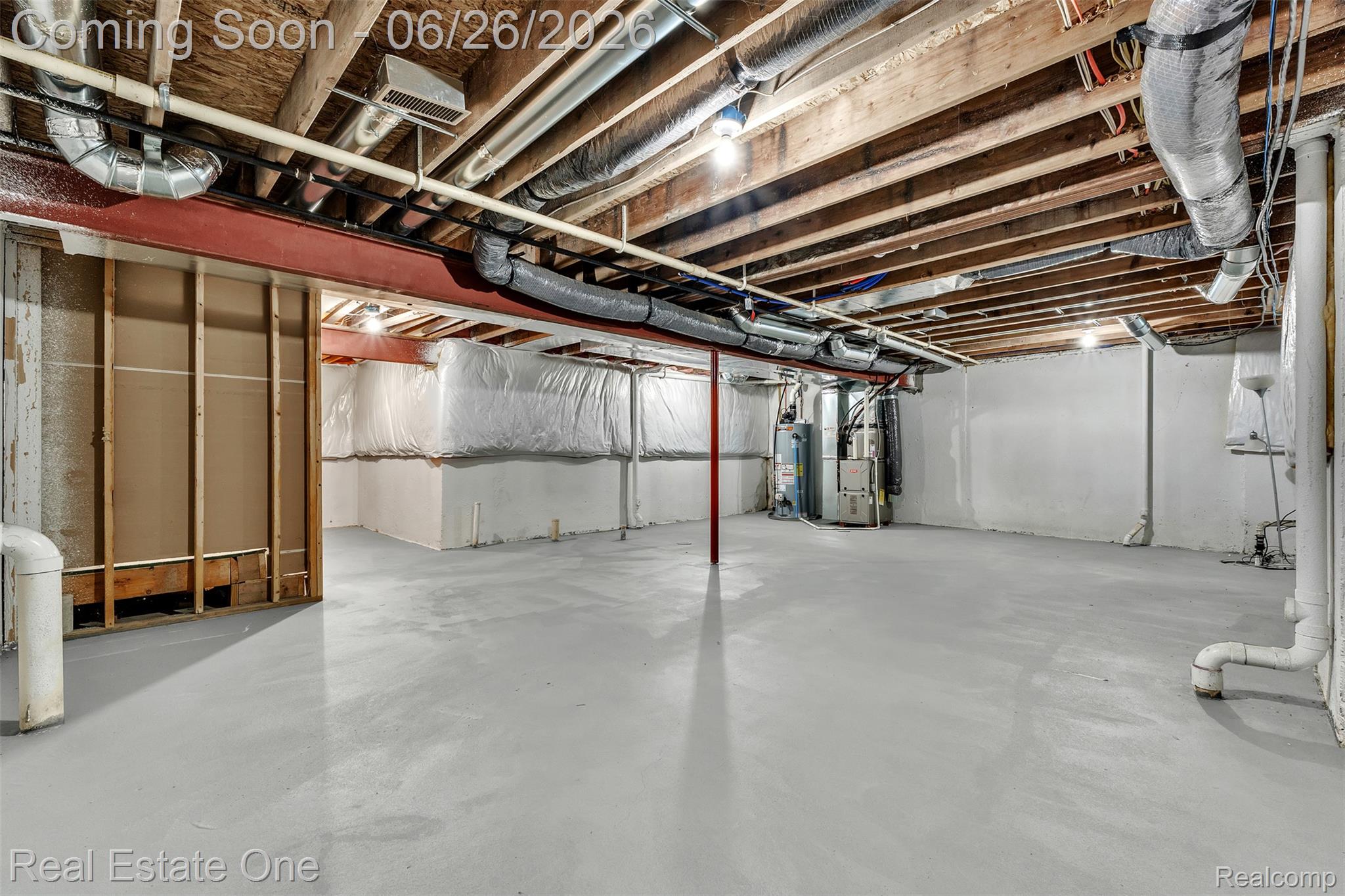 41590 Mitchell Road Novi, MI 48377 - Photo 36 of 45 Expansive unfinished basement featuring a painted concrete floor, exposed wooden ceiling joists, and visible utility systems