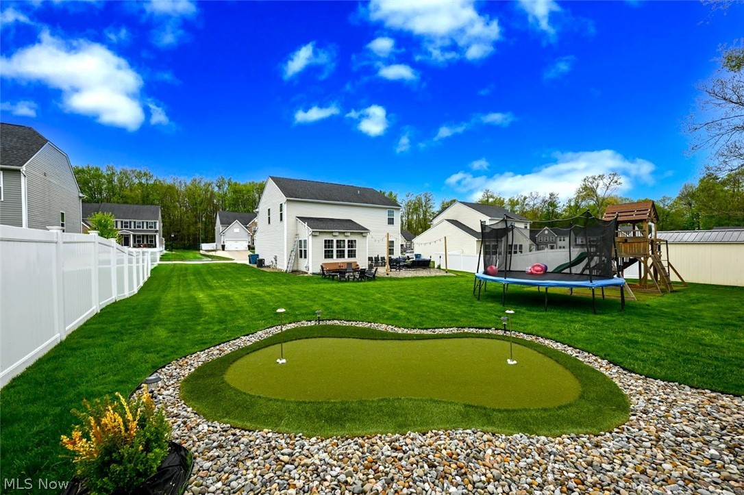 3021 Stonehurst Road Uniontown, OH 44685 - Photo 3 of 48 *SURROUNDED BY NEIGHBOR PRIVACY FENCING ~ A PUTTING GREEN INSTALLED W/STONE & ROCK SURROUND FOR GOLF ENTHUSIASTS, PLAYGROUND W/TURF, BACK PATIO AND FIREPIT! ~