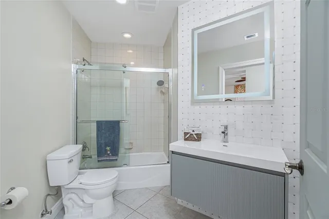 a view of a dining room with furniture a rug and wooden floor