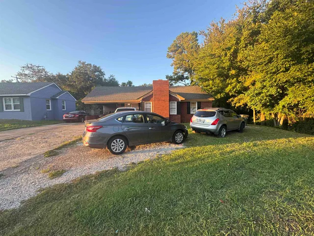 a view of a car parked in front of a house
