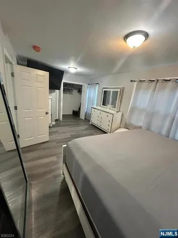 a bedroom with a bed and a mirror