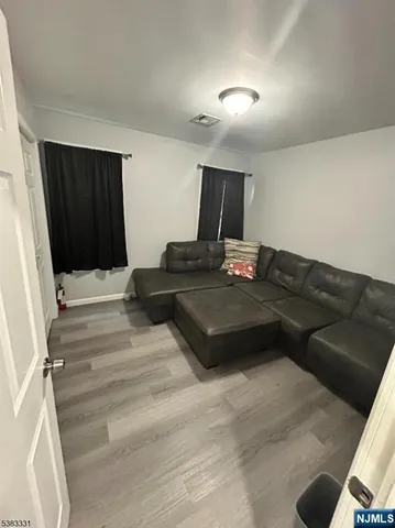 a bedroom with a bed window and dresser