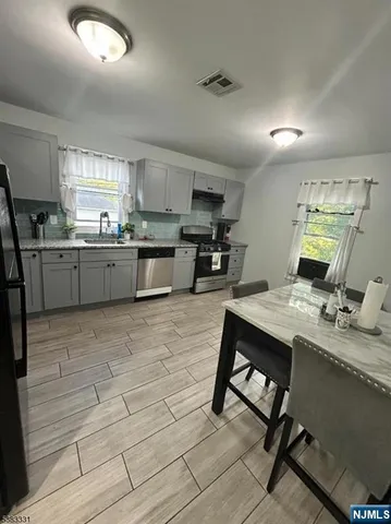 a kitchen with a sink cabinets and window