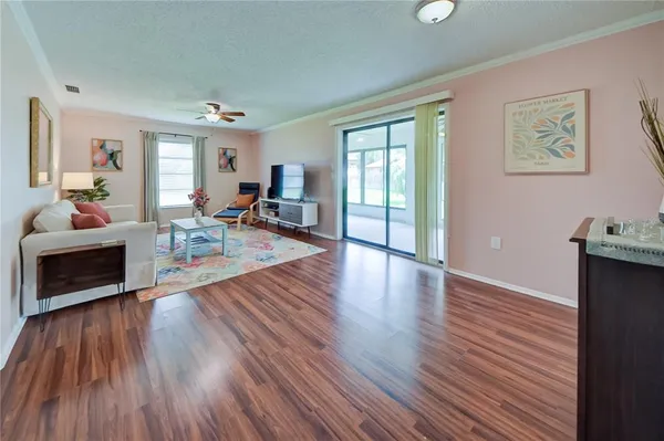 a living room with furniture and wooden floor