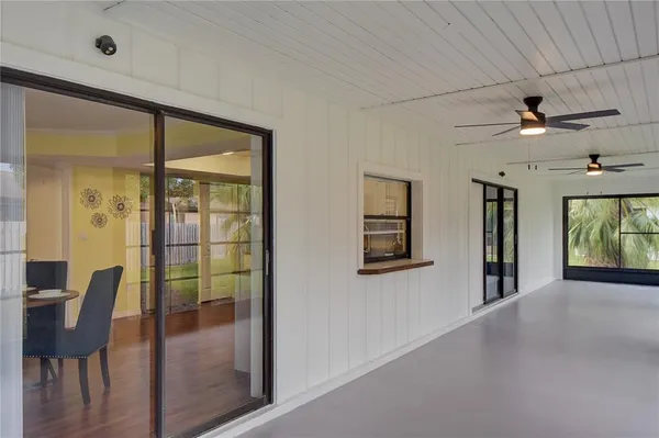 a view of a hallway with furniture and window