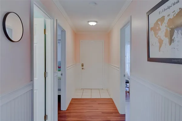 a view of a hallway with wooden floor