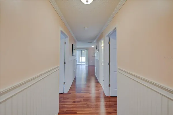 a view of a hallway with wooden floor