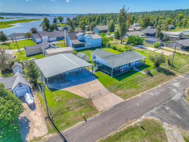 an aerial view of a house with garden space and street view