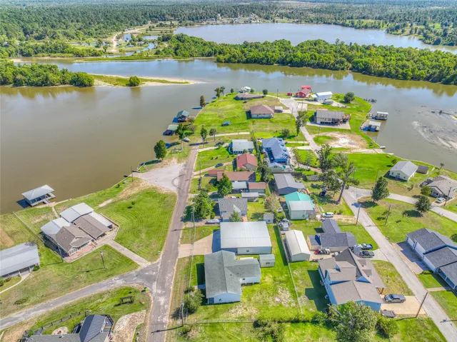 an aerial view of a house with a lake view