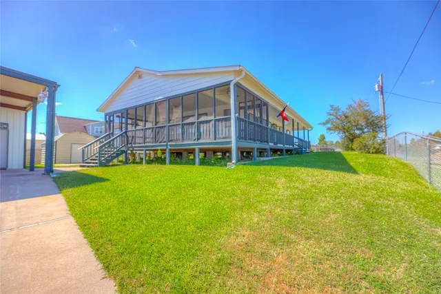 a view of a house with a yard and sitting area