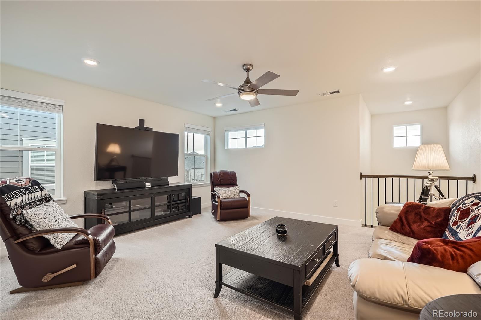946 Compass Drive Erie, CO 80516 - Photo 12 of 28 a living room with furniture and a flat screen tv