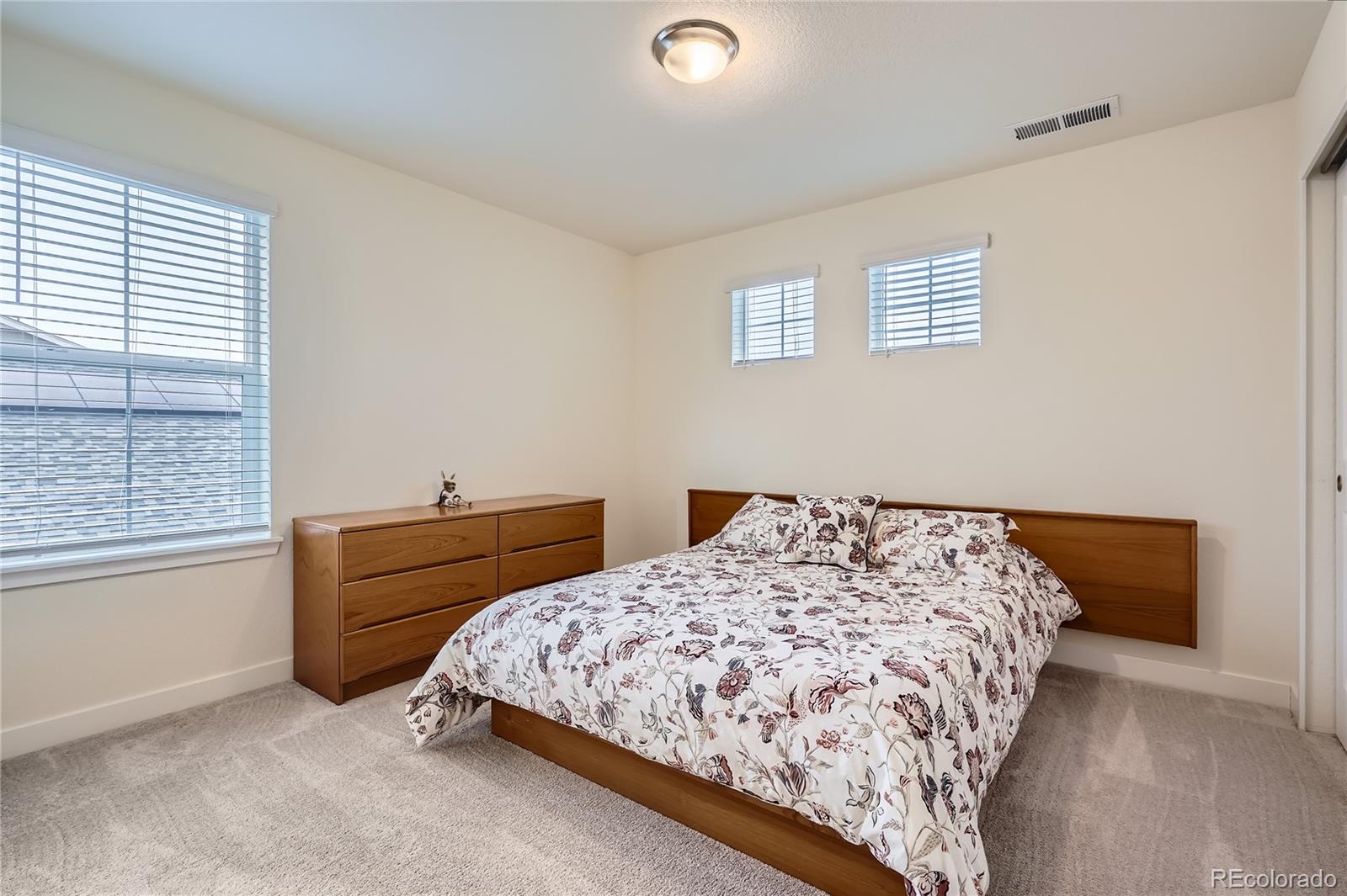 946 Compass Drive Erie, CO 80516 - Photo 20 of 28 a bedroom with bed and window