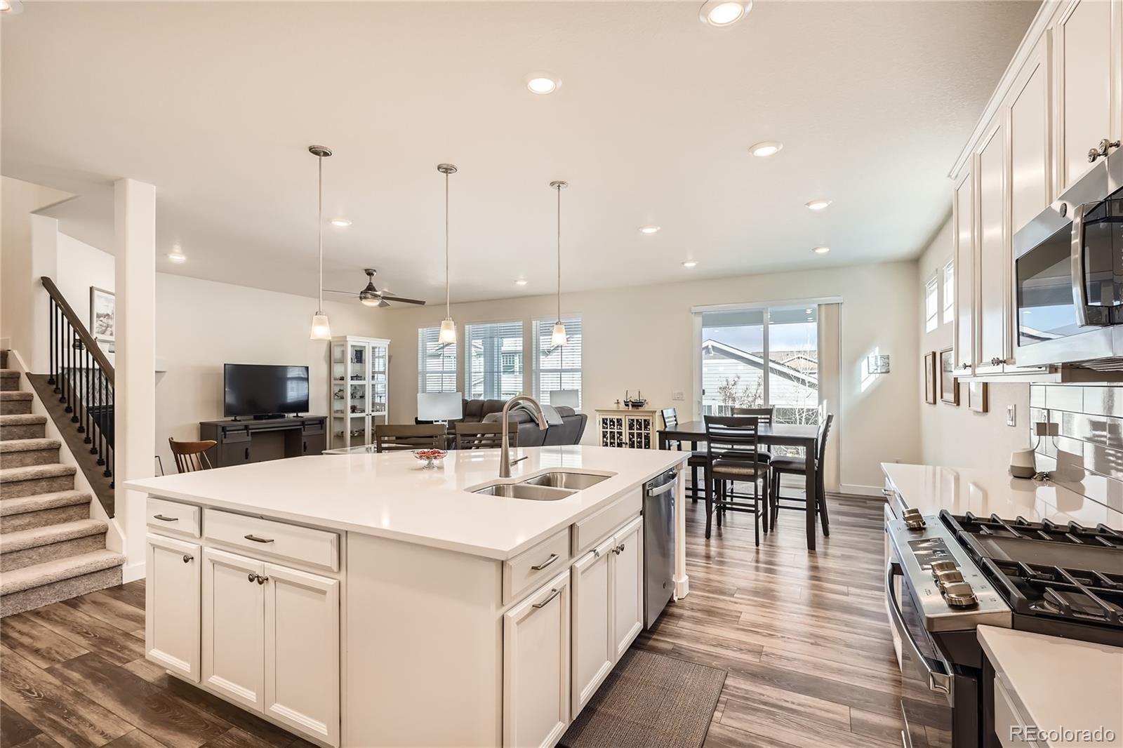 946 Compass Drive Erie, CO 80516 - Photo 5 of 28 a kitchen with stove and chairs