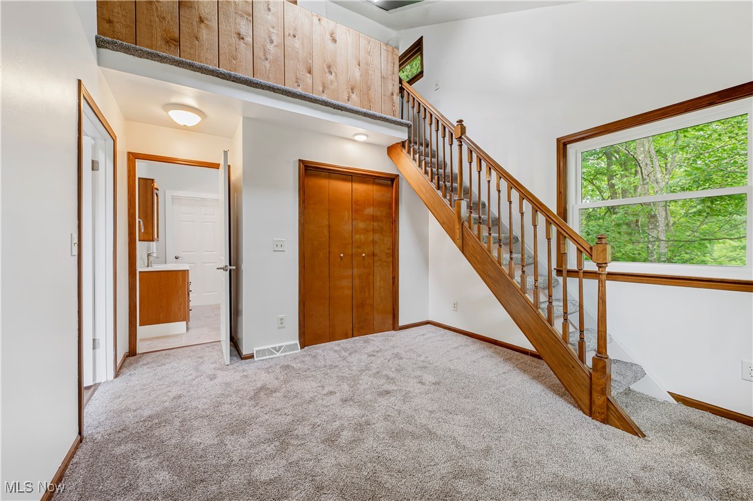 12358 Harmon Road New Springfield, OH 44443 - Photo 25 of 44 Stairway featuring carpet floors and a towering ceiling