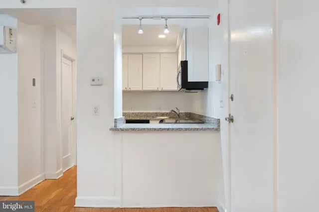 a kitchen with stainless steel appliances granite countertop a stove microwave and refrigerator