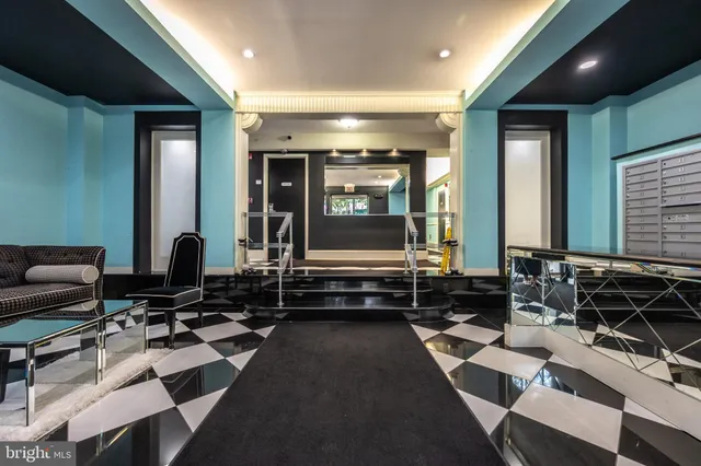 a living room with furniture a rug floor and a flat screen tv