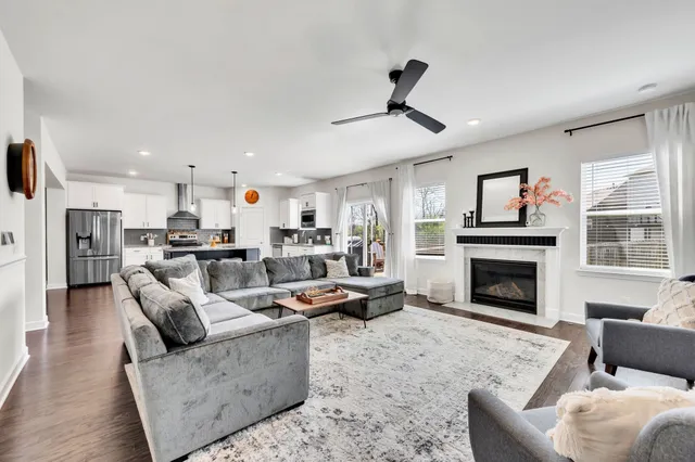 a living room with furniture kitchen and a fireplace