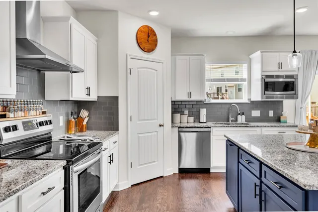 a kitchen with a sink cabinets and stainless steel appliances