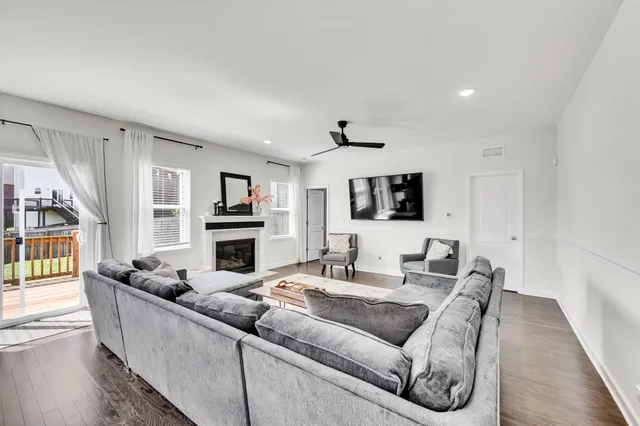 a living room with furniture flat screen tv and a fireplace