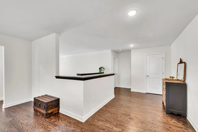 a hallway with window and a wooden floor