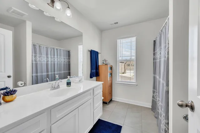 a bathroom with a tub sink and mirror