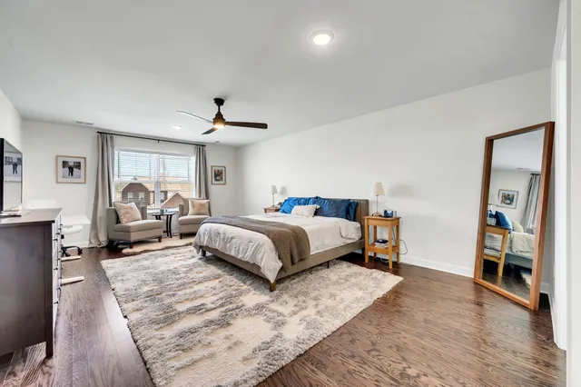 a bedroom with a large bed and a chandelier