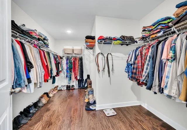 a view of walk in closet with clothes