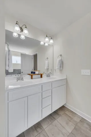 a bathroom with a double vanity sink and a mirror