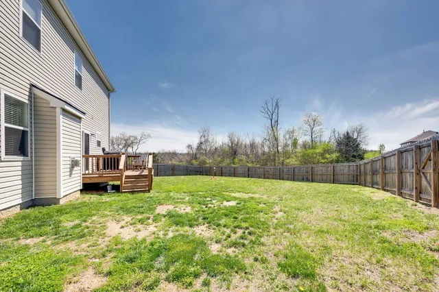 a view of a backyard with white house