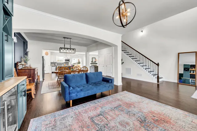 a living room with furniture and a chandelier