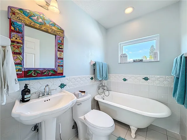 a bathroom with a sink mirror vanity and toilet
