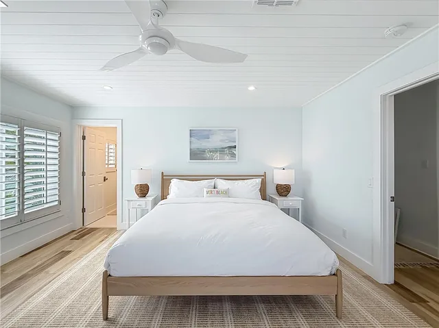 a bedroom with a large bed and a large window