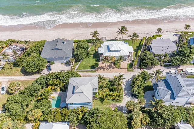 an aerial view of a house with a garden and yard