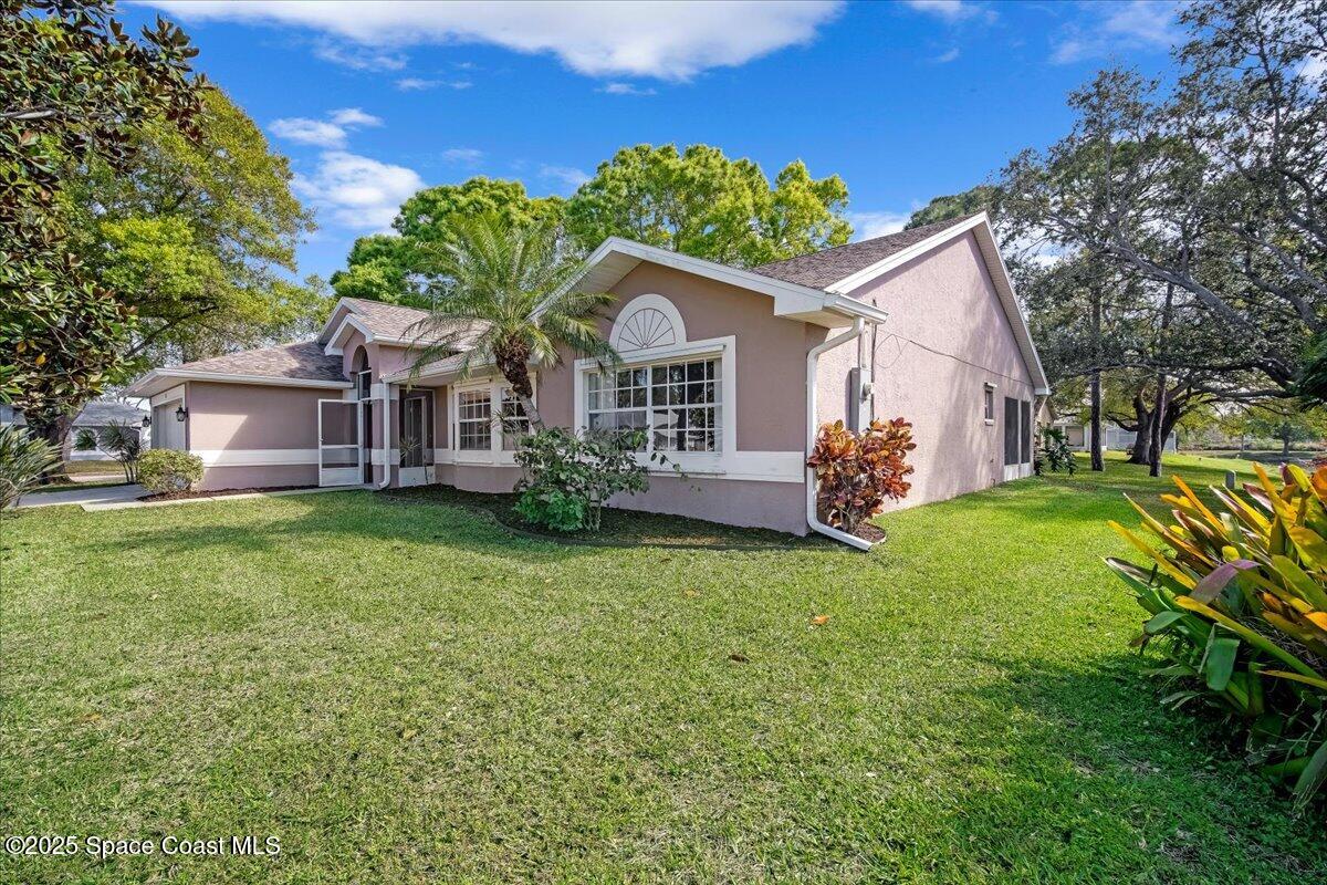295 Oak Lake Road Melbourne, FL 32901 - Photo 3 of 40 a front view of a house with garden