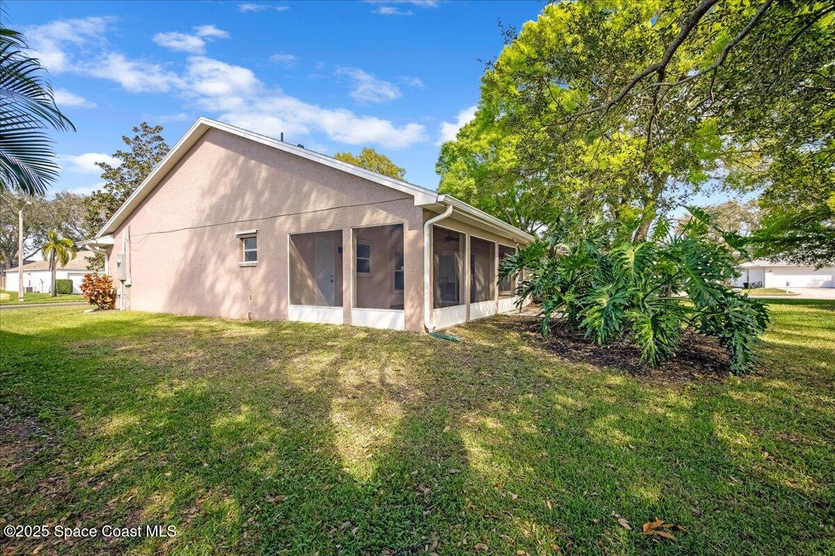 295 Oak Lake Road Melbourne, FL 32901 - Photo 33 of 40 a view of a house with a yard
