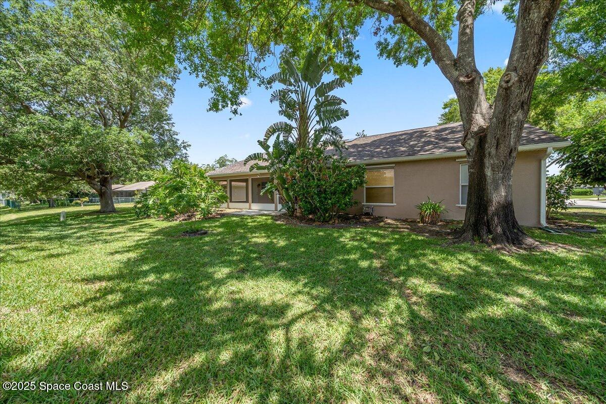 295 Oak Lake Road Melbourne, FL 32901 - Photo 35 of 40 a view of backyard of house with green space
