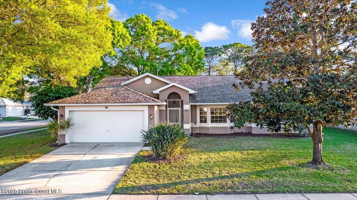 295 Oak Lake Road Melbourne, FL 32901 - Photo 39 of 40 a front view of a house with garden