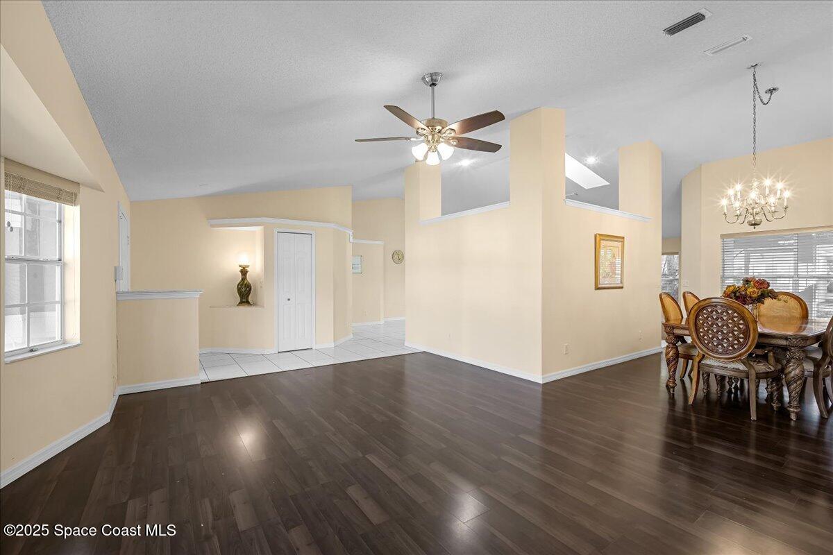 295 Oak Lake Road Melbourne, FL 32901 - Photo 5 of 40 wooden floor in an empty room with a window