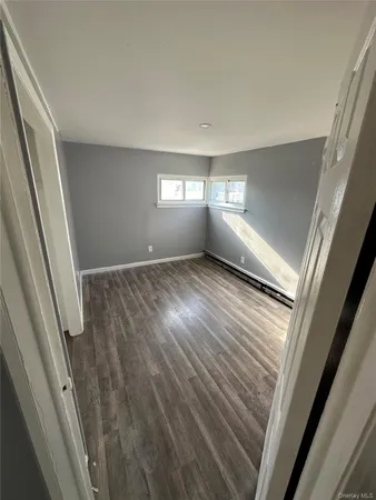 a view of a room with wooden floor and staircase